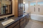 Master bath has double vanities and large soaking tub.
